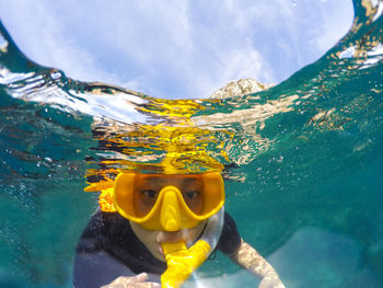 Portrait of teenage girl snorkeling in sea