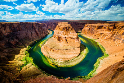 Scenic view of rock formations against cloudy sky