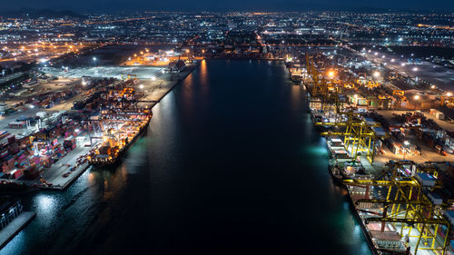 High angle view of city lit up at night