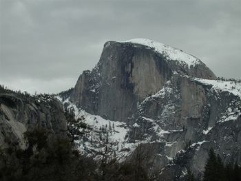 Low angle view of frozen mountain against sky