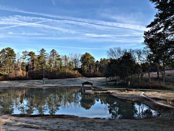 Scenic view of lake in forest against sky