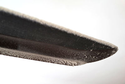 Close-up of wet metal against white background