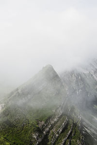 Scenic view of mountains against sky during foggy weather