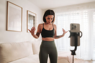 Portrait of young woman exercising in gym