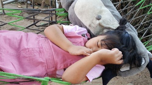 Rear view of girl sitting on horse sleeping