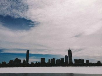 Cityscape against cloudy sky