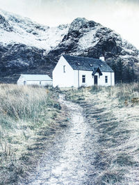 Base camp cottage at snowy glencoe in the scottish highlands, cold sunny morning. hipster filter.