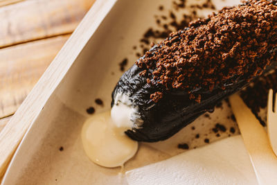 Dark chocolate bread with white creamy custard in a cafe.