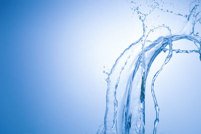 Close-up of icicles against clear blue sky