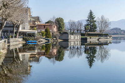 The town of pusiano is reflected in the water of its lake