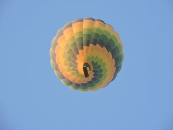 Low angle view of hot air balloon against clear blue sky