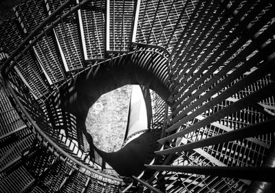 Close-up of man standing on metal staircase