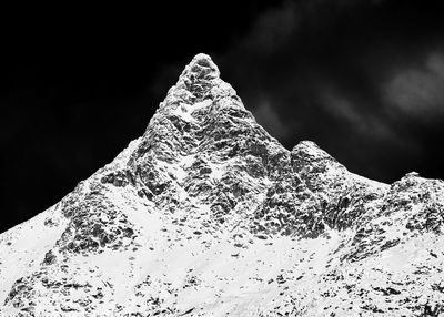 Low angle view of snowcapped mountain against sky