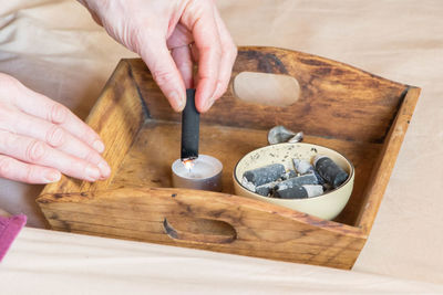 Cropped hands burning incense