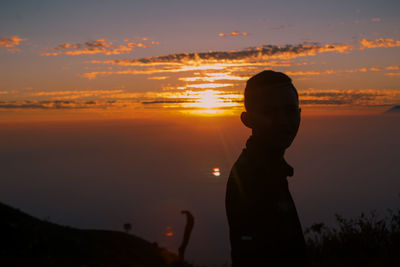 The sun sets over mount merbabu