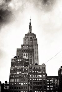 Low angle view of buildings against cloudy sky