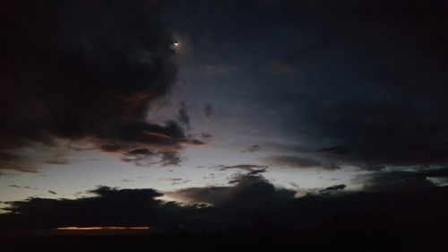 Low angle view of cloudy sky at night