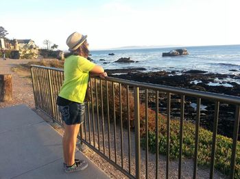 Rear view of woman overlooking sea