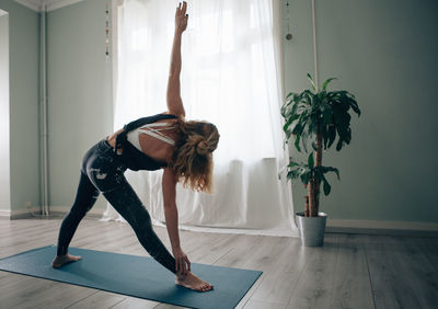 Yogic woman practicing in yoga studio