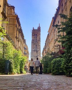 People walking in front of historical building