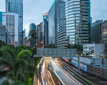 Light trails on street amidst buildings in city