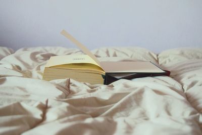 Close-up of book on bed at home