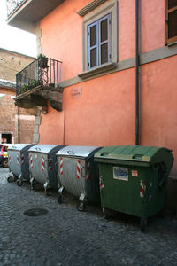 Garbage bin against buildings in city