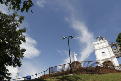 Low angle view of street and buildings against sky