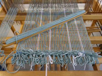 Wooden loom tools on a weaving loom with wool