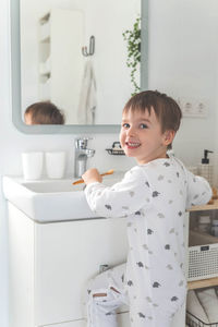 Portrait of cute boy looking through window