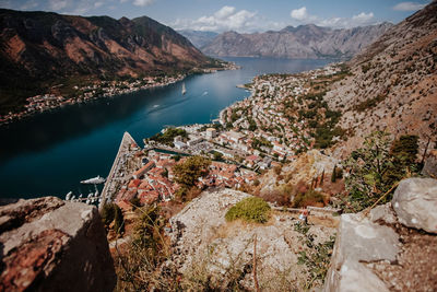 High angle view of lake and mountains against sky