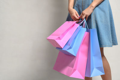 Low section of woman holding umbrella on paper