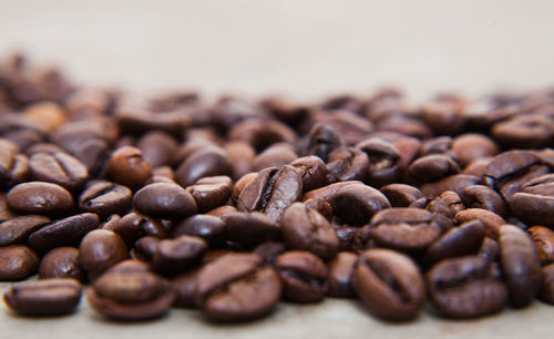 Close-up of roasted coffee beans on table