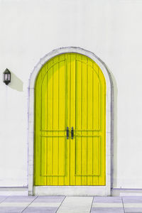 Yellow closed door of building