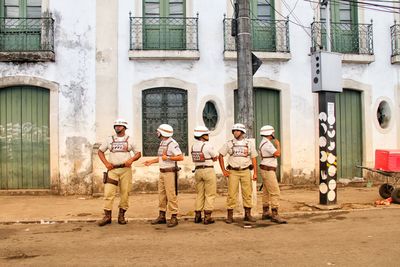 Portrait of people standing outside building