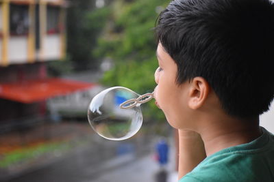 Portrait of boy holding bubbles