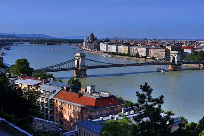 High angle view of bridge over river by buildings in city