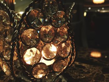 Close-up of illuminated lighting equipment on glass table