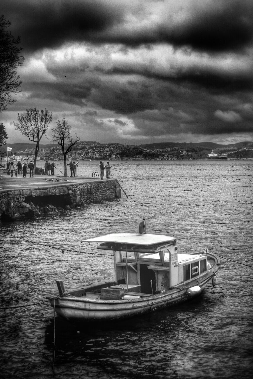 water, sky, cloud - sky, cloudy, sea, nautical vessel, tranquil scene, waterfront, tranquility, scenics, weather, beauty in nature, overcast, boat, cloud, nature, rippled, transportation, horizon over water, storm cloud