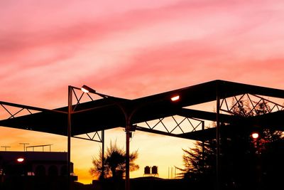 Low angle view of built structure at sunset