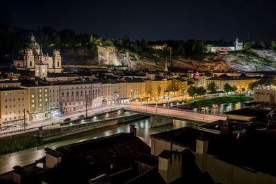 High angle view of illuminated street and buildings at night