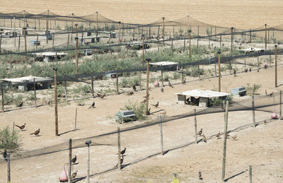 High angle view of field seen through fence