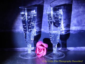 Close-up of glass of water on table against black background