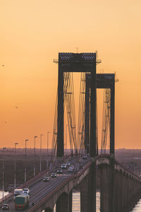 Bridge against sky during sunset in city