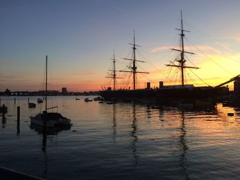 Sailboats in marina at sunset