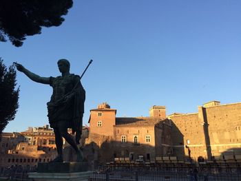 Low angle view of statue against clear blue sky