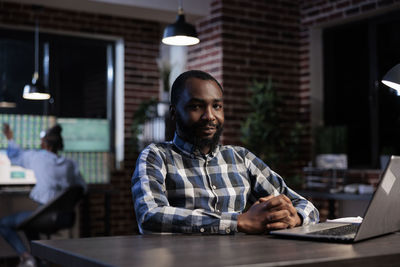 Portrait of businessman sitting at office