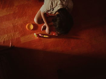 High angle view of boy sitting on table