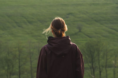 Rear view of woman looking at camera