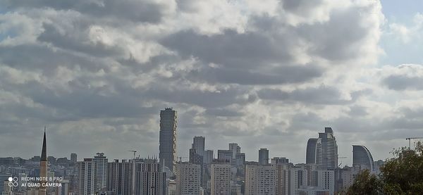 Modern buildings in city against sky